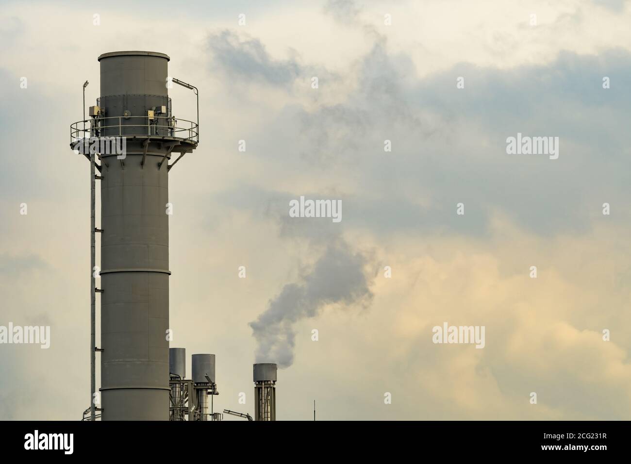 Air pollution from factory. Black smoke from chimney of industrial pipe. Global warming problem concept. Air pollutant emission factors. Stock Photo