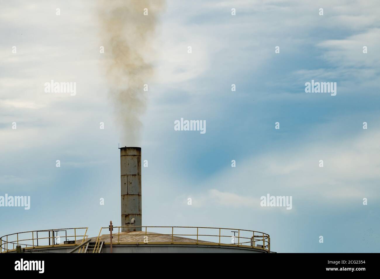 Air pollution from factory. Black smoke from chimney of industrial pipe. Global warming problem concept. Air pollutant emission factors. Air contamina Stock Photo