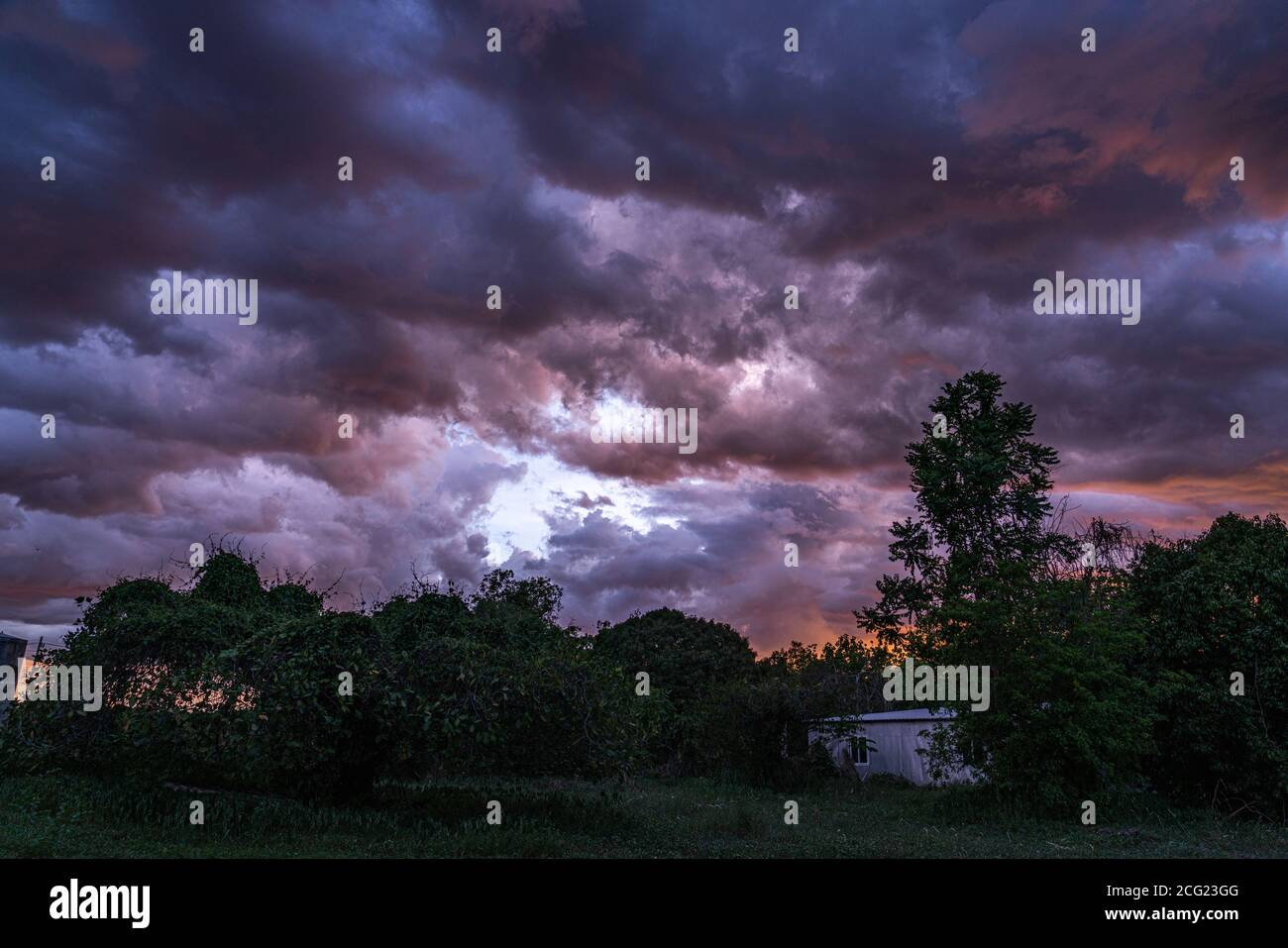 Dark stormy rain clouds flow over the sky in the evening in rainy season. Stock Photo
