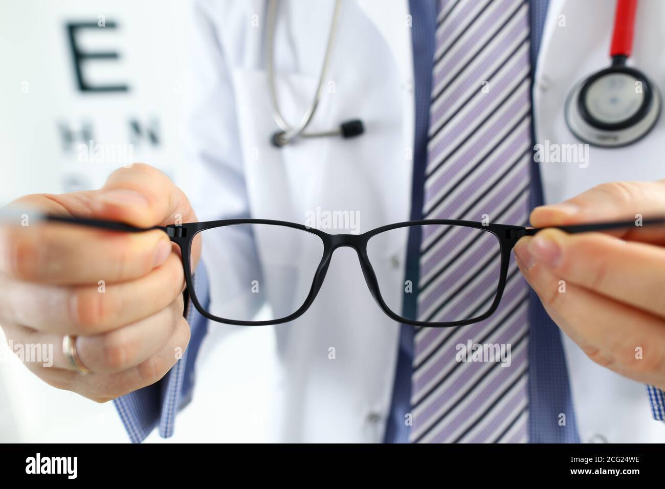 Male medicine doctor hands giving pair of black glasses Stock Photo Alamy