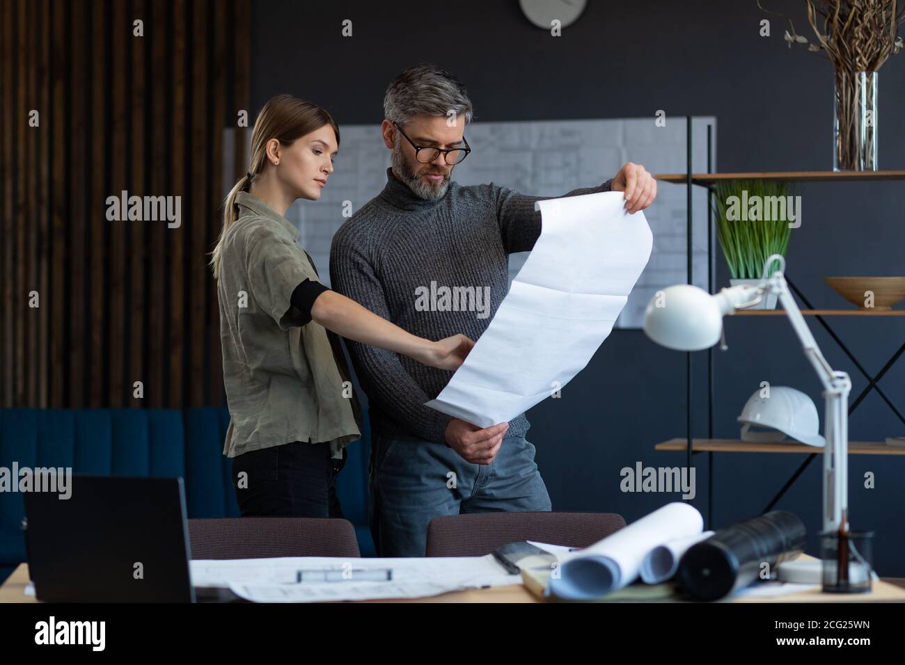 Engineer team working in office with blueprints and architect equipment ...