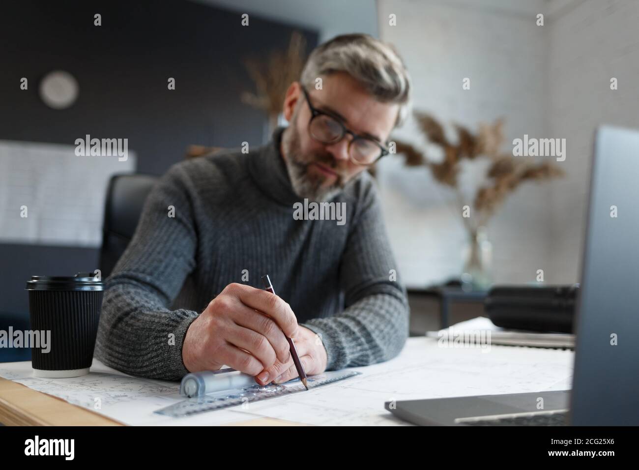 Interior designer working in office with blueprints.Engineer inspect ...