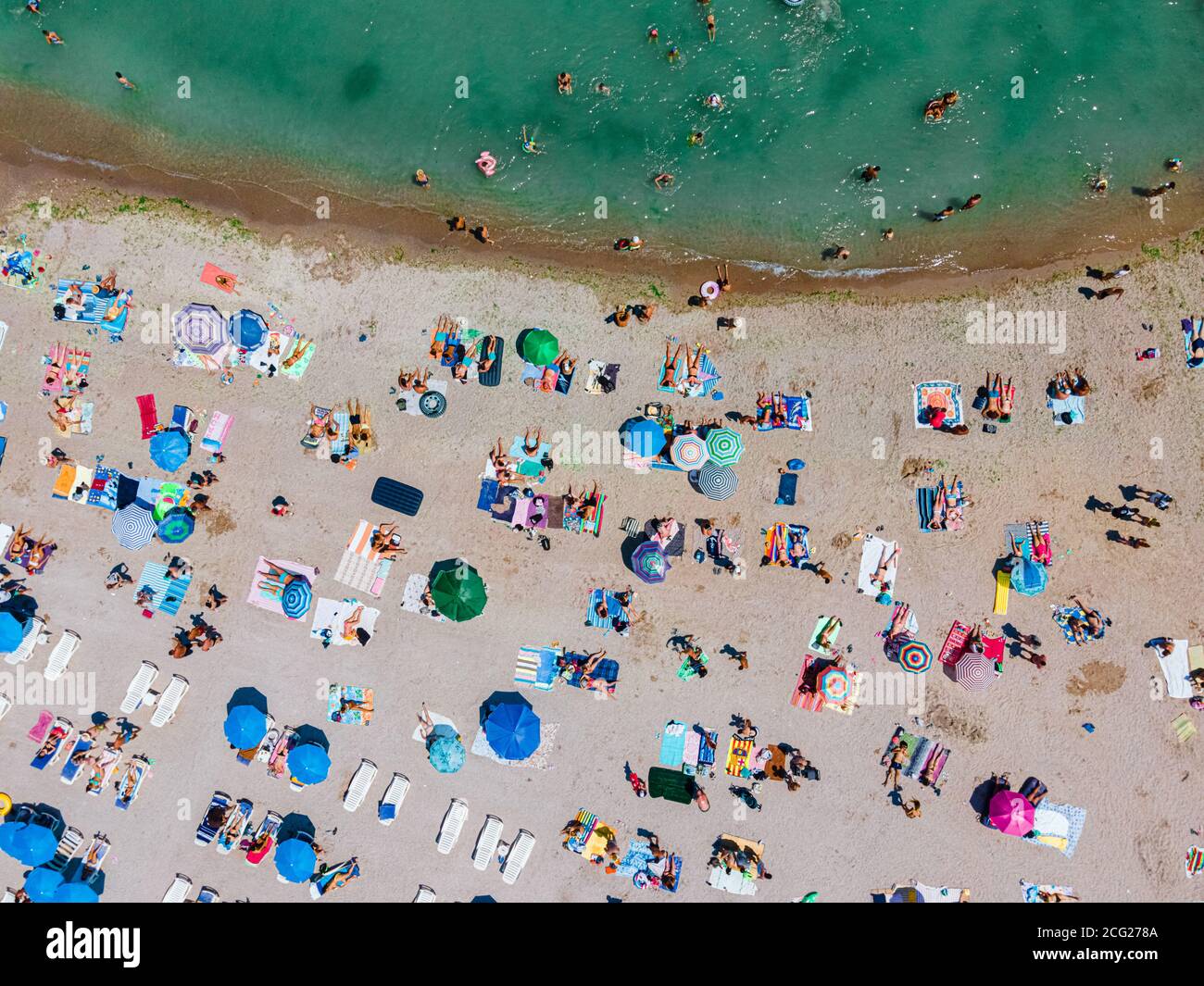 Aerial Beach Drone Photography, People And Umbrellas On Sea Beach Stock Photo