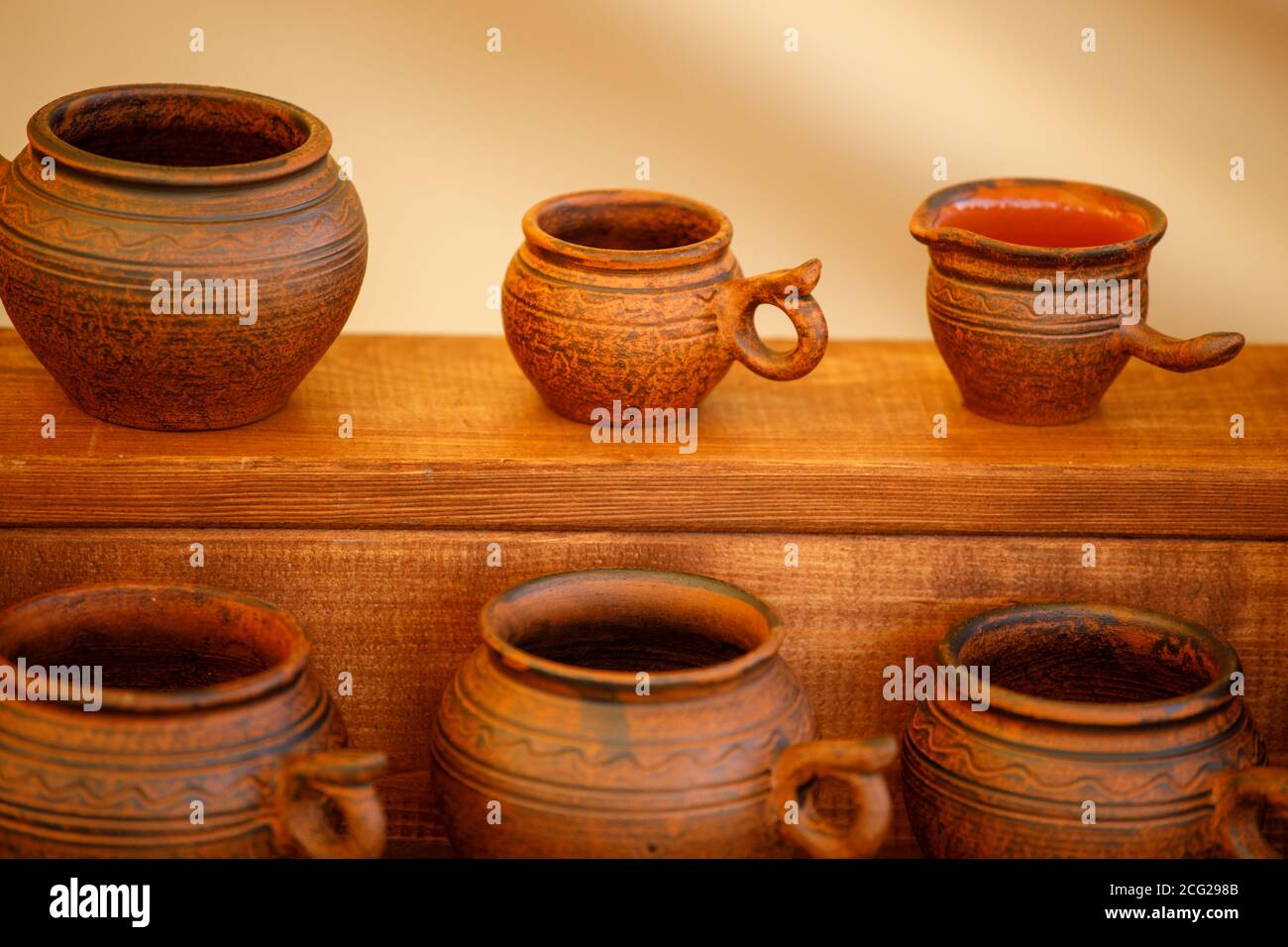 brown clay pots are in rows. handmade Stock Photo Alamy
