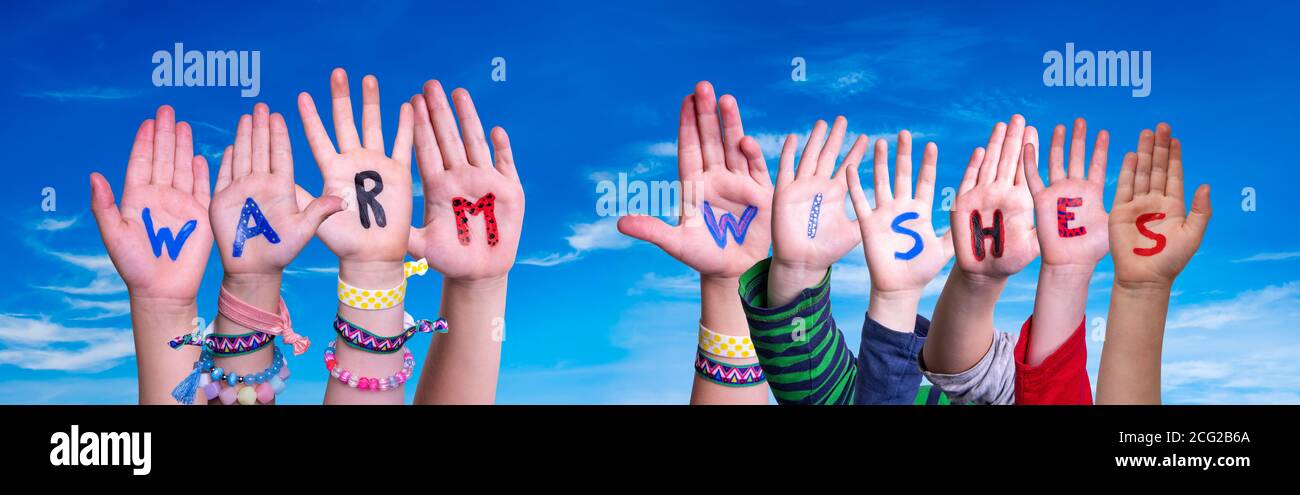 Children Hands Building Word Warm Wishes, Blue Sky Stock Photo