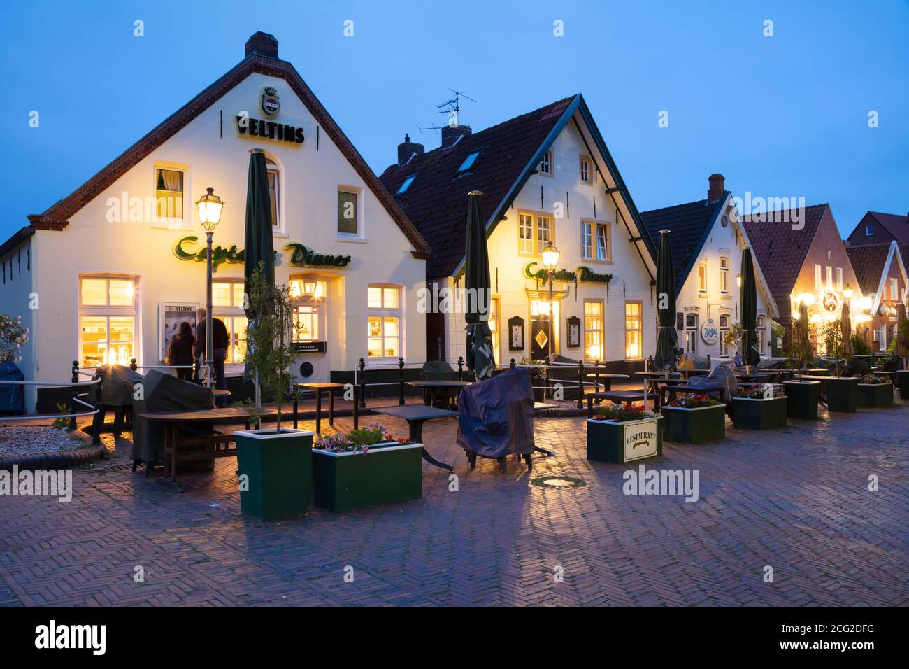 Public houses at the market by night, Greetsiel, East Frisia, Lower saxony, Germany, Europe Stock Photo