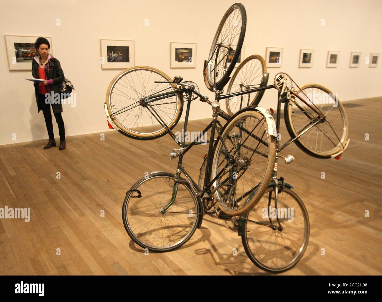 A visitor views 'Four Bicycles (There is Always One Direction)' by artist Gabriel Orozco, part of a new exhibition of the artist's work, at Tate Modern, in Southwark, central London, which runs from January 19th to April 25 2011. Stock Photo
