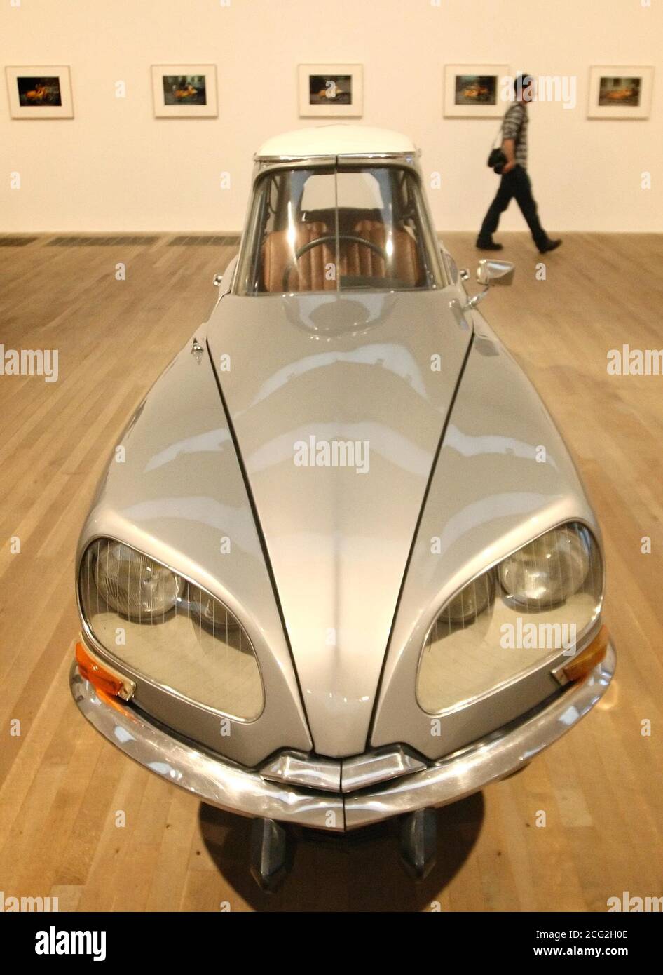 A visitor views 'La D.S.' a modified Cirtroen DS car, by artist Gabriel Orozco, part of a new exhibition of the artist's work, at Tate Modern, in Southwark, central London, which runs from January 19th to April 25 2011. Stock Photo
