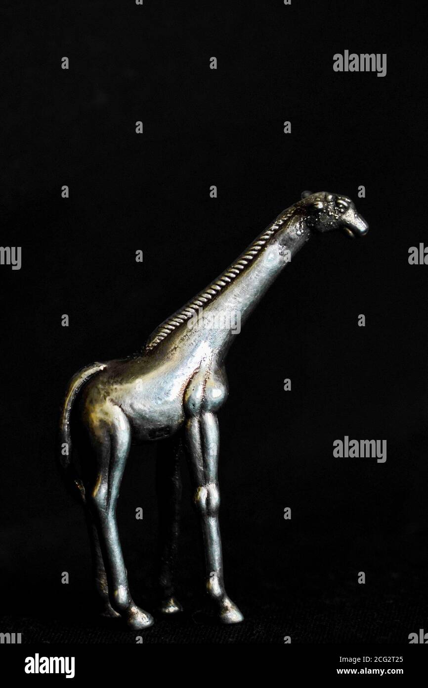 Giraffe statuette on black background Stock Photo