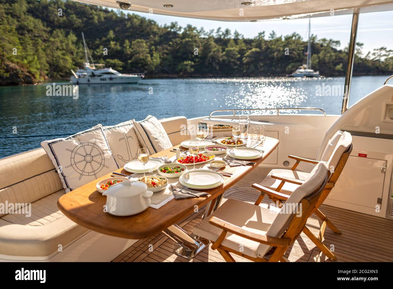 Romantic Dinner on Motor Yacht at Sunset Stock Photo