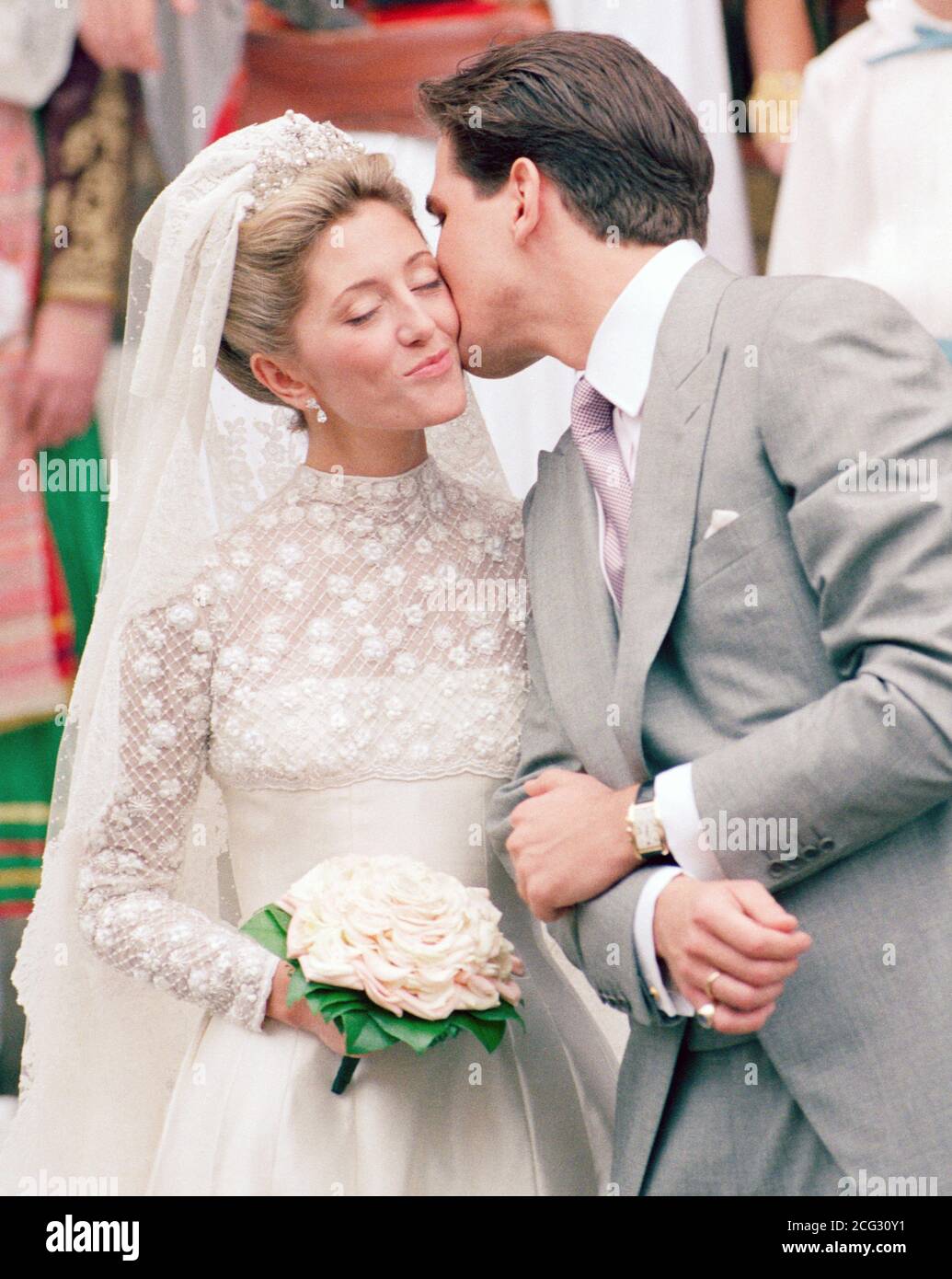 The exiled Crown Prince Pavlos of Greece kisses his bride Marie-Chantal Miller after their wedding at the Greek Orthadox Cathedral of St Sophia in Bayswater, London.   * Royalty from all over the world including 12 senior members of the British royal family, attended the no-expense spared ceremony. Stock Photo