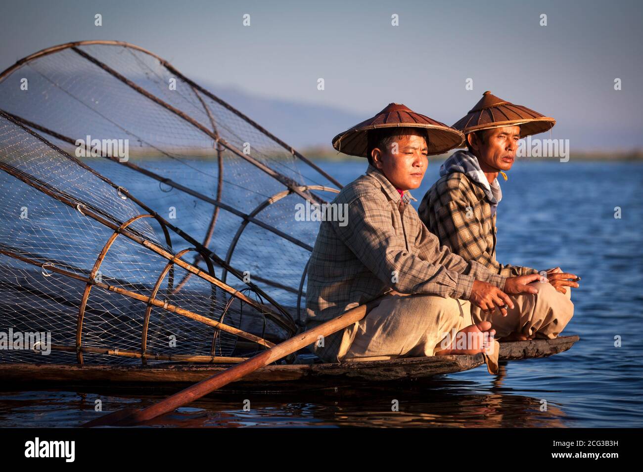 Lake, Inle, Myanmar, 17th November 2014: lake Inle fishermen smoking on thier boat in early ours of a day during surise Stock Photo