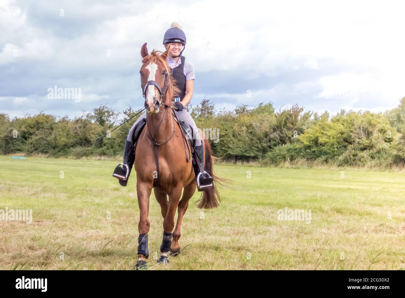 HORSE RIDING THROUGH FIELDS AND OVER JUMPS Stock Photo Alamy