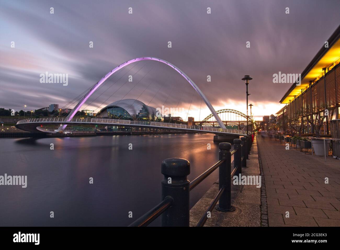 The Gateshead Millennium Bridge spanning the River Tyne captured at dusk from Newcastle quayside looking up the River Tyne. Stock Photo