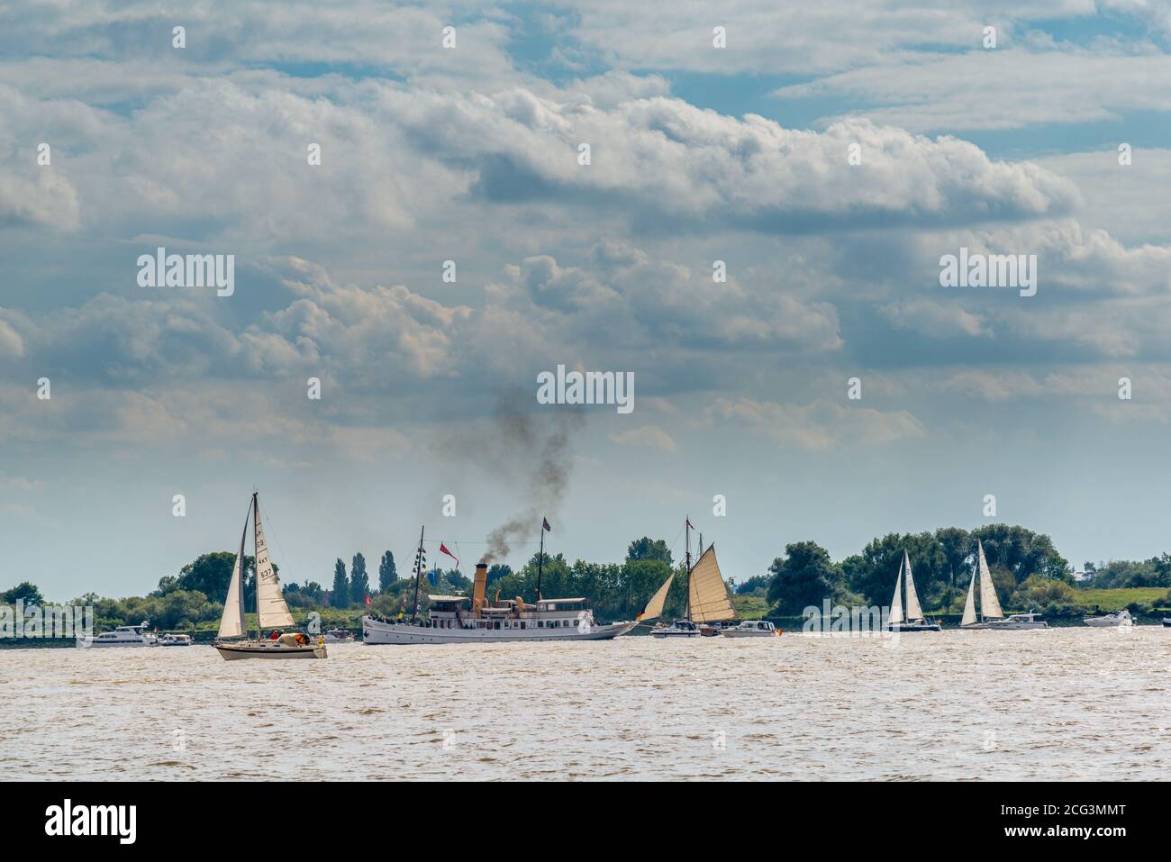 Yachts and the vintage steamer 'Scharhörn' on the Elbe River in front of the island Lühesand, Lower Saxony, Germany Stock Photo