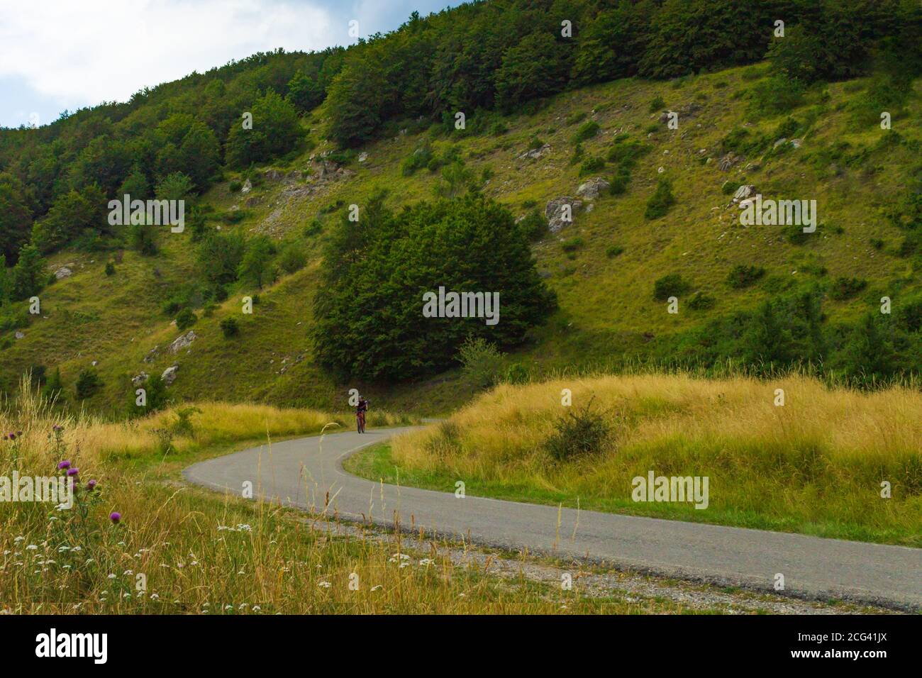 Cyclist riding along mountain road hi res stock photography and images Cyclist riding along mountain road hi res stock photography and images