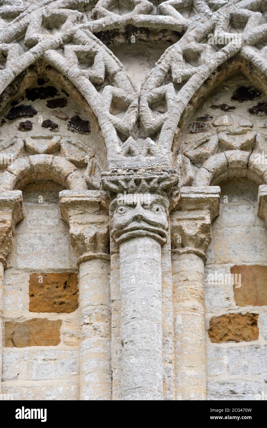 Norman carving on west front of St Lawrence church, Castle Rising in Norfolk. Stock Photo