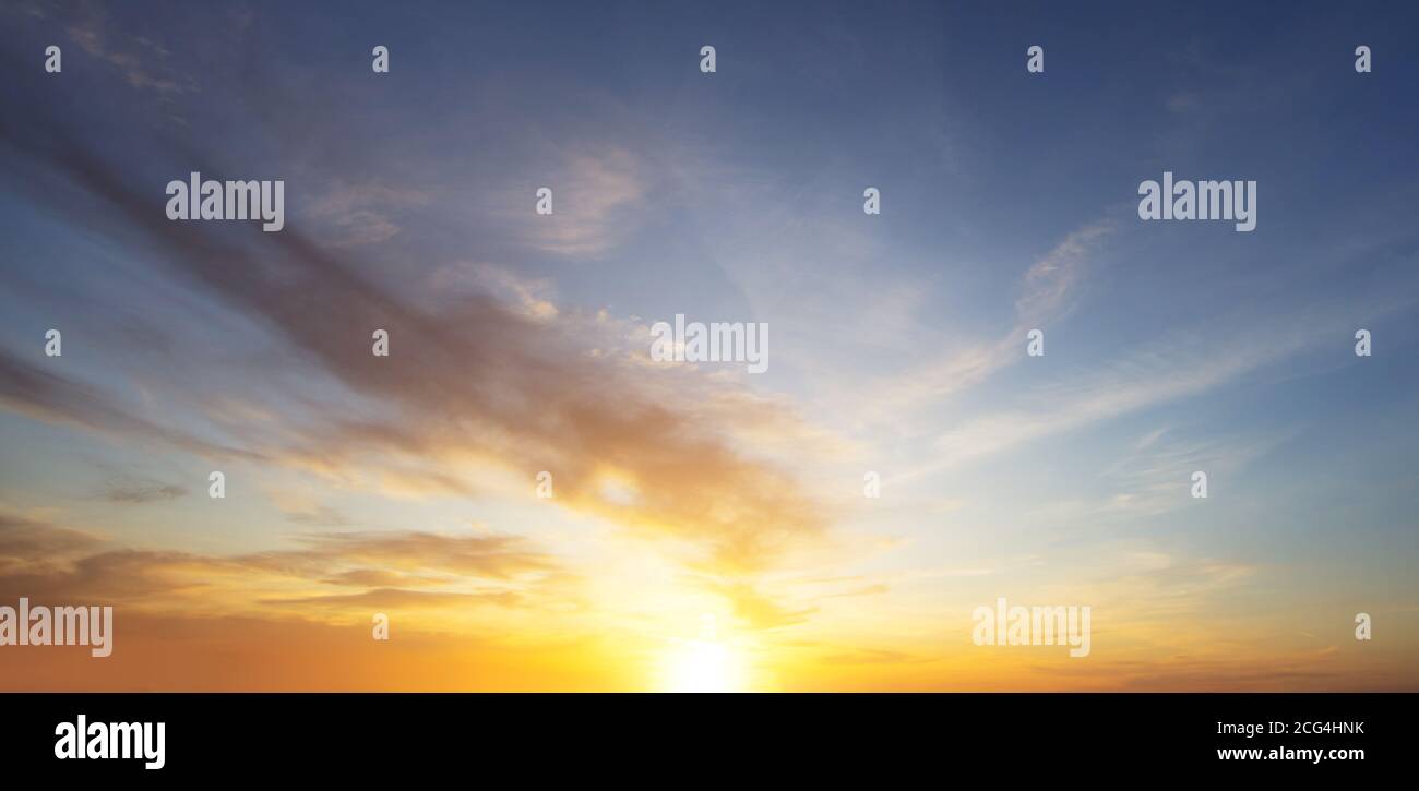 Beautiful sunset sky with clouds and falling sun Stock Photo