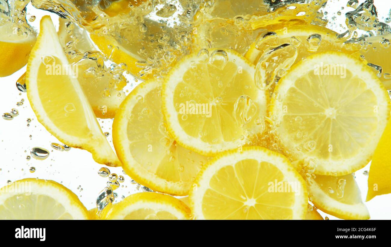 Lemon Slices falling deeply under water isolated on white background Stock Photo