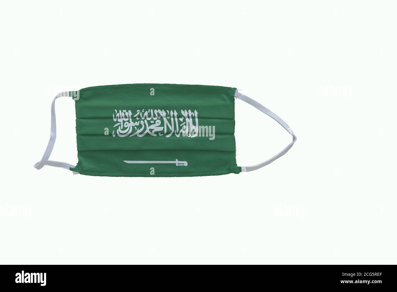 Saudi Arabian  flag design Covid-19 pandemic  virus face mask  on a white background with copy space Stock Photo