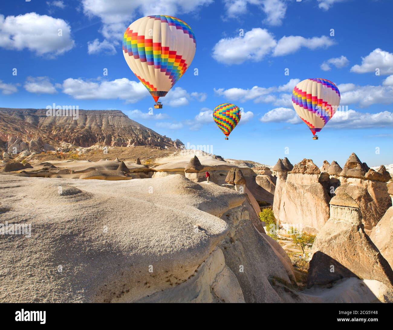 Hot air balloon flying over rock landscape at Cappadocia Turkey Stock ...