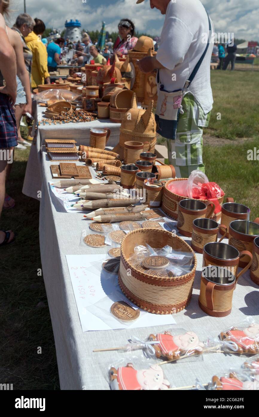 Souvenirs of birch bark are on the exhibition counter during the ethnic festival Karatag on the shore of a Large lake. Stock Photo