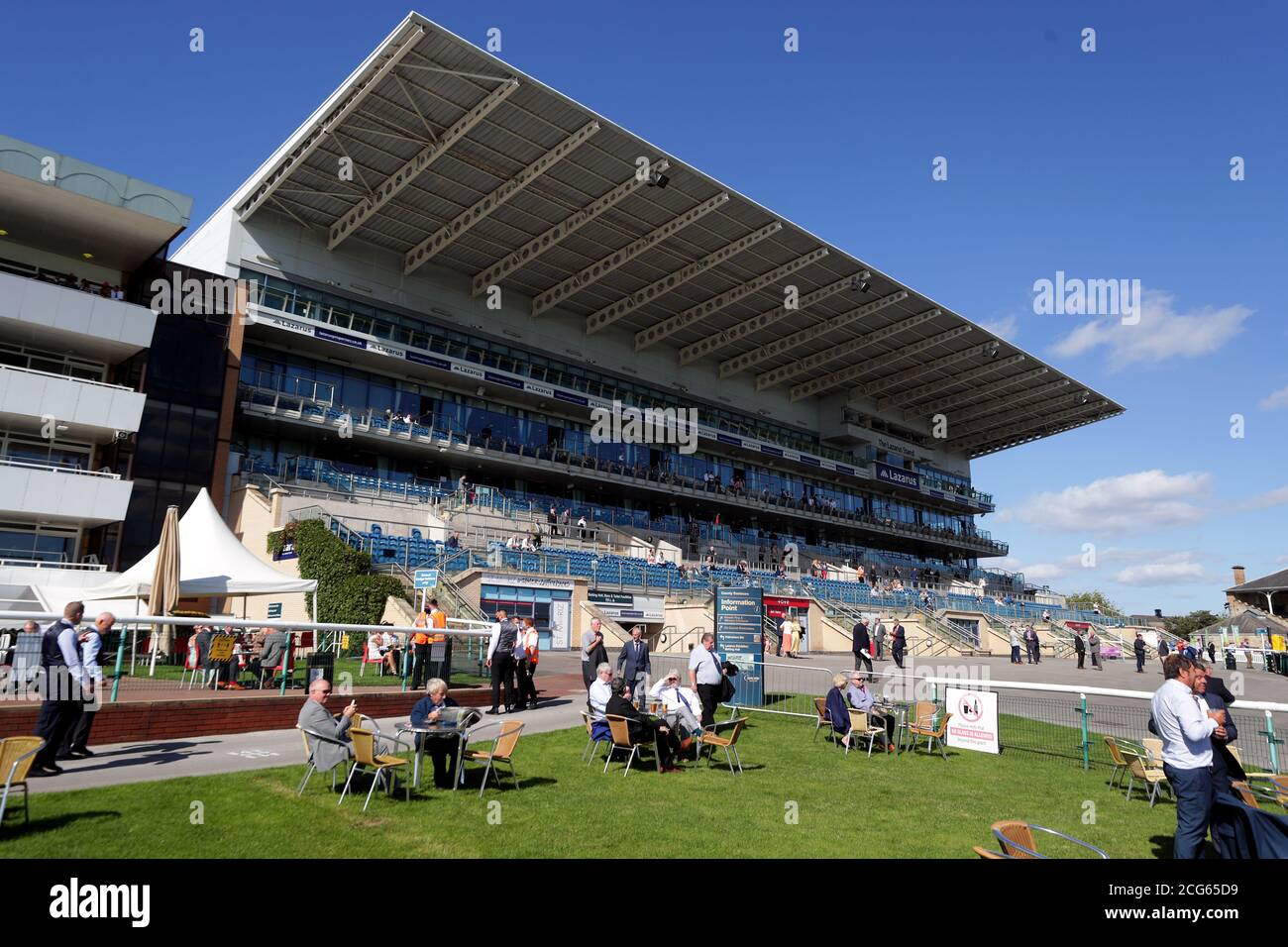 Racegoers next to the course and in the stands as a pilot scheme for the return of crowds to sporting events is expected to bring in 2500 spectators during day one of the William Hill St Leger Festival at Doncaster Racecourse. Stock Photo