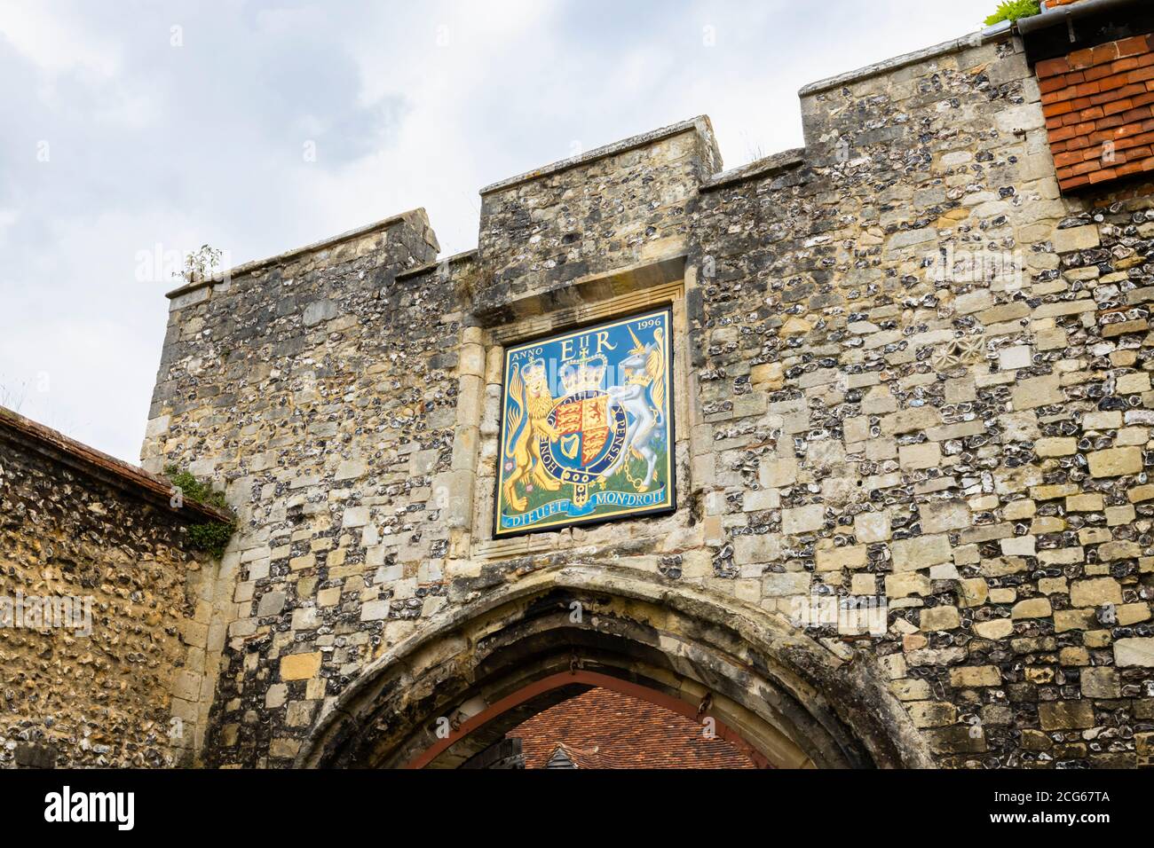 Dieu et mon droit on the Royal coat of arms of the United Kingdom above the Priory Gate entrance to Cathedral Close, Winchester, Hants, south England Stock Photo