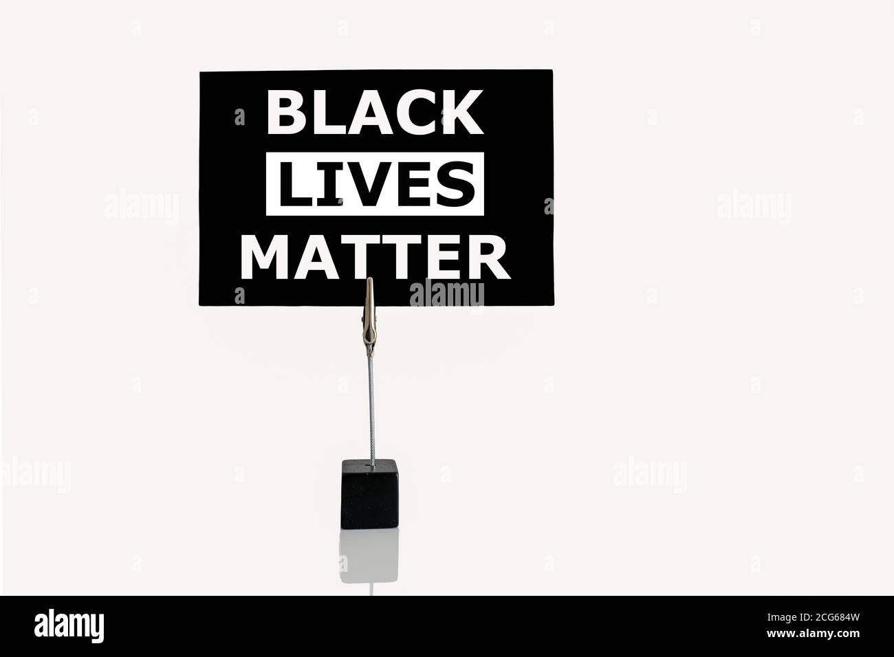 Black Lives Matter banner flag mounted in cube base photograph holder for  office desk Stock Photo
