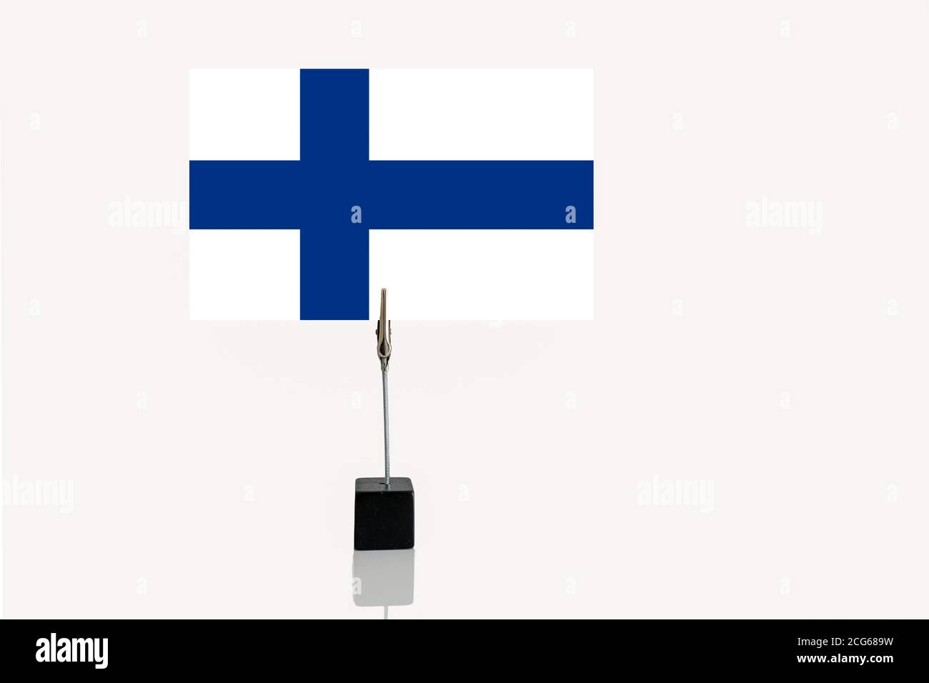 Democratic Republic of Finland miniature flag in cube base in photograph holder on a white background Stock Photo