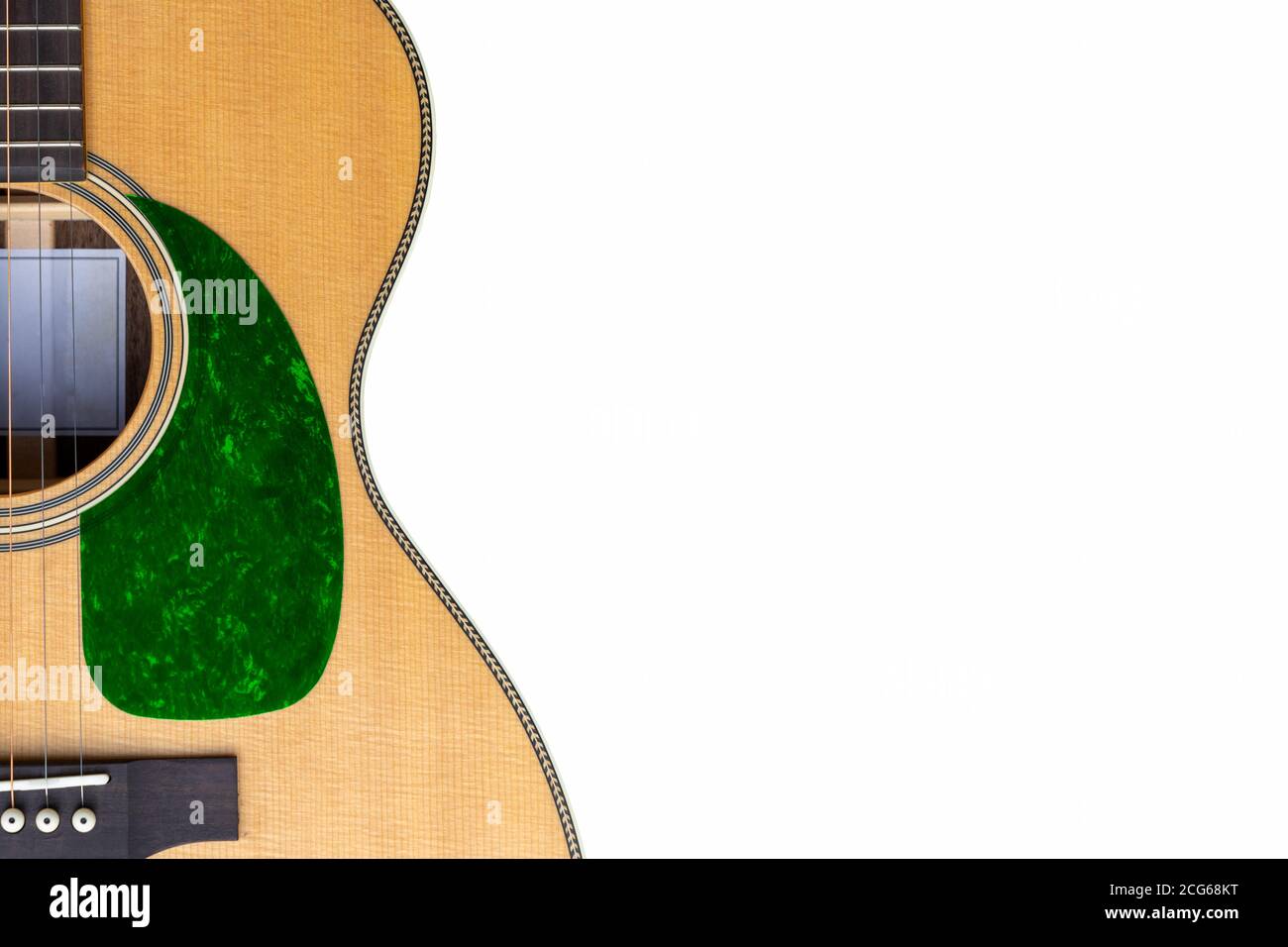 Sitka Acoustic guitar green pickguard on a white background with copy space Stock Photo