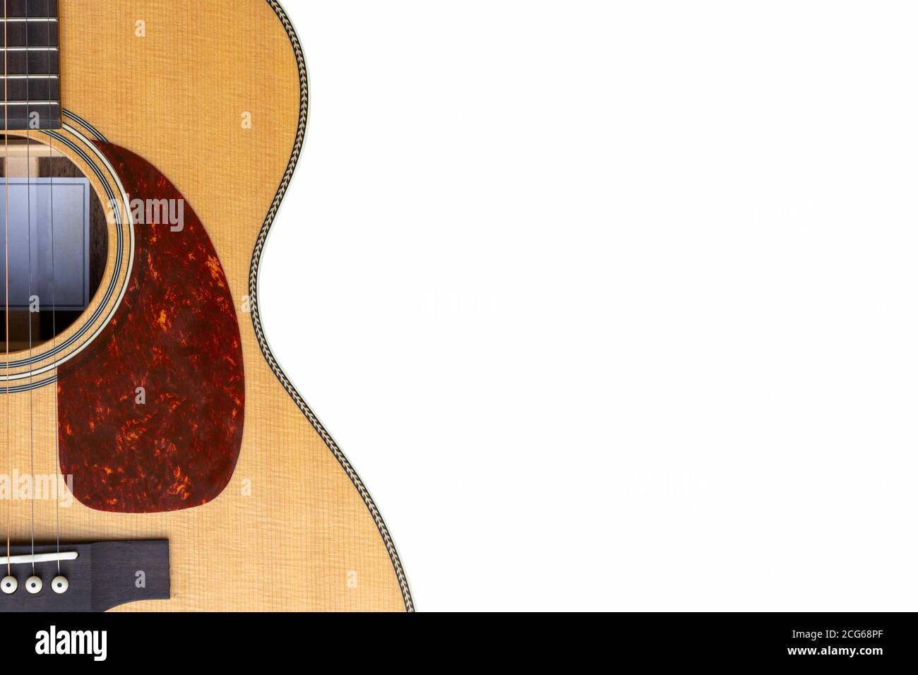 Sitka  top Acoustic guitar red   pickguard on a white background with copy space Stock Photo