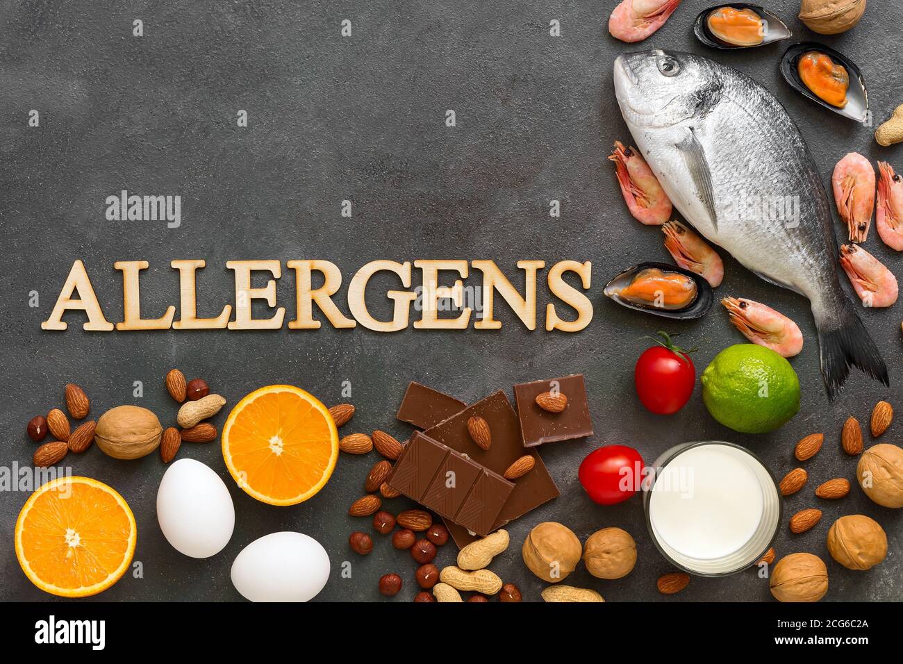 Food allergens. Seafood, milk, chocolate, nuts, citrus fruits, eggs. Allergy food concept. Top view, flat lay, copy space Stock Photo