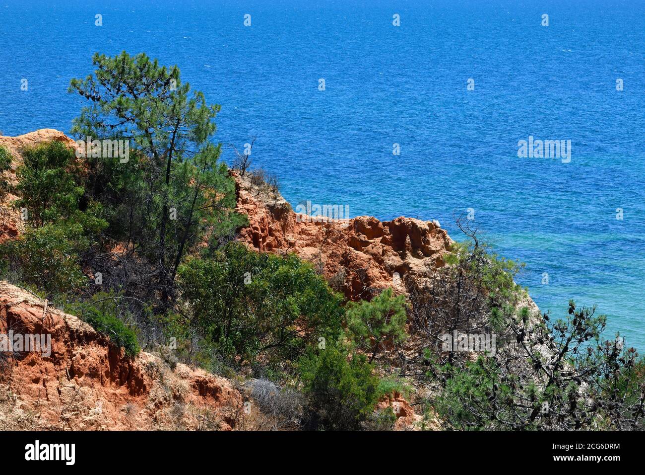 Colored cliff of limestone rocks and the Atlantic Ocean, Olhos de Agua, Algarve, Portugal Stock Photo