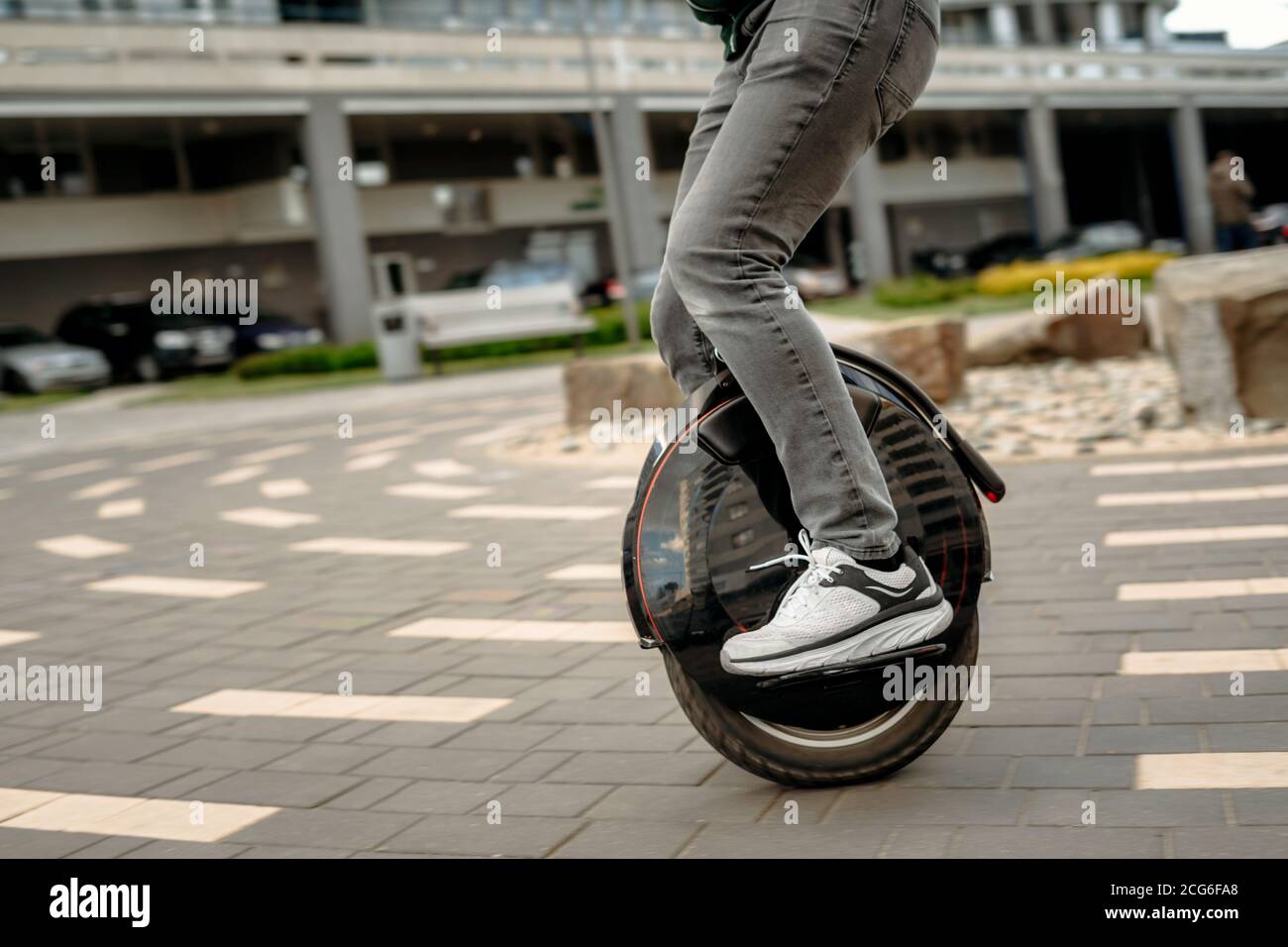Man riding unicycle on street, electric unicycle close up. Stock Photo