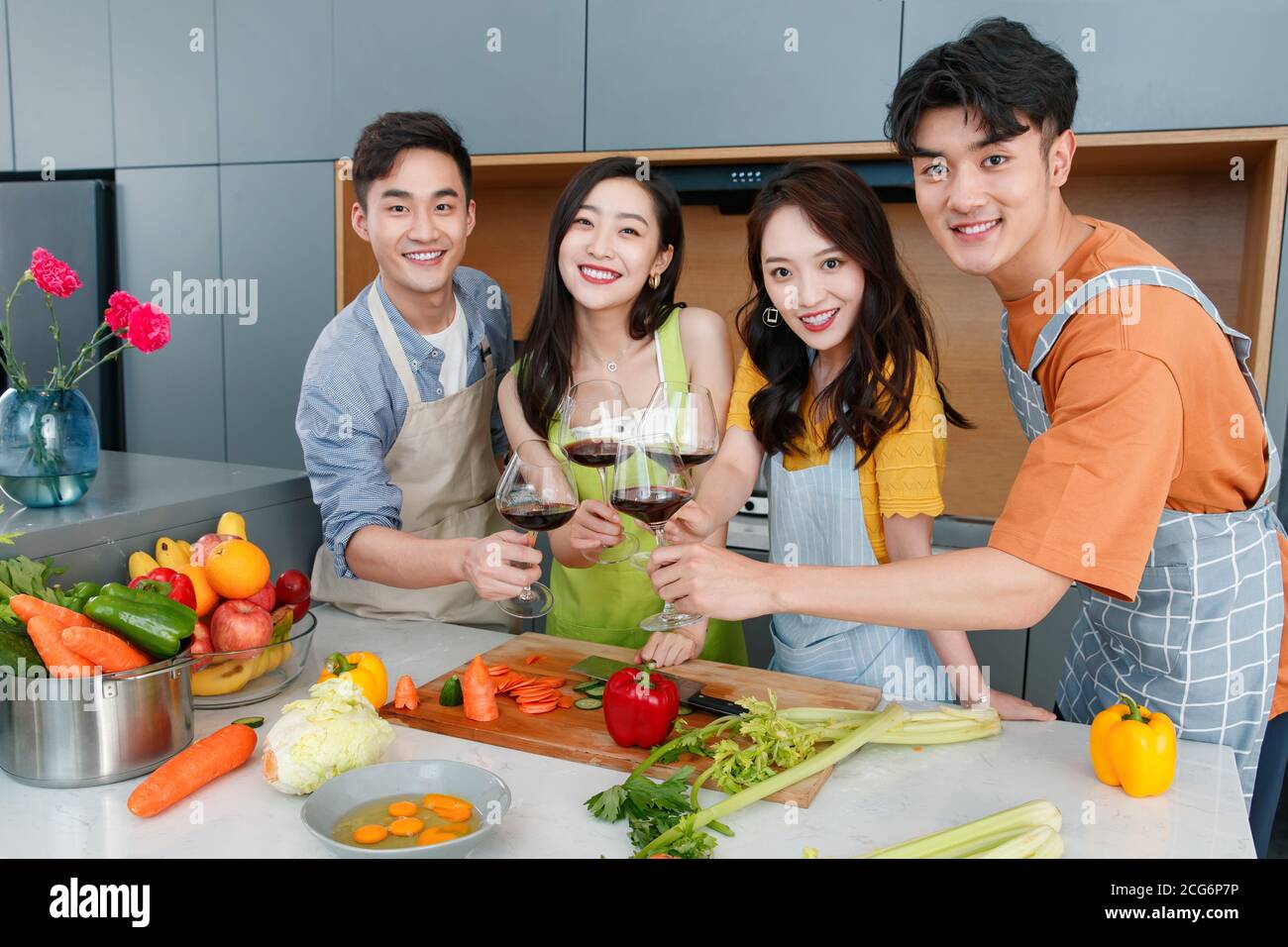 Happy young cook while drinking red wine Stock Photo