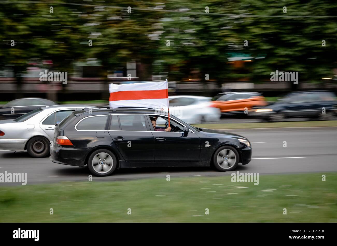 Minsk, Belarus - August 21, 2020: Belarusian people participate in peaceful protest after presidential elections in Belarus. Car passenger holds a whi Stock Photo
