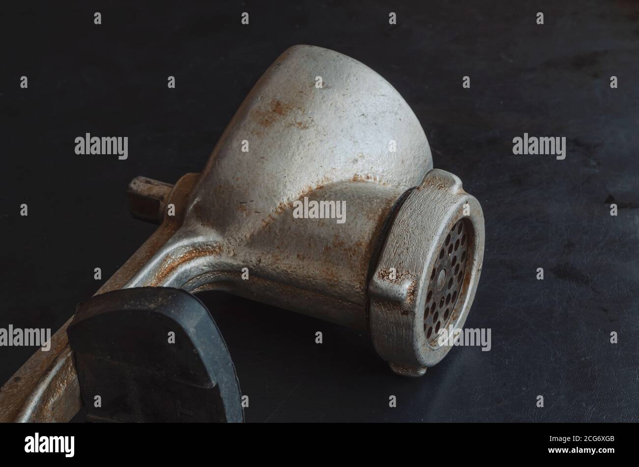 https://c8.alamy.com/comp/2CG6XGB/manual-vintage-meat-grinder-on-a-black-background-hand-tool-for-grinding-various-products-antique-kitchen-utensils-2CG6XGB.jpg