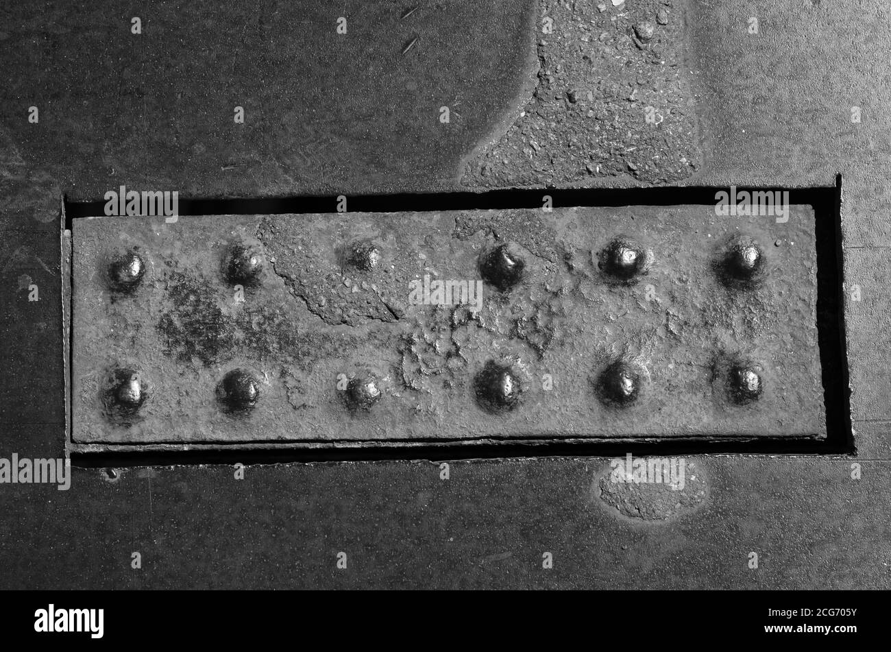 Worn Rivets Old rusty rectangular plate with rivets on a metal surface. Fragment of ...