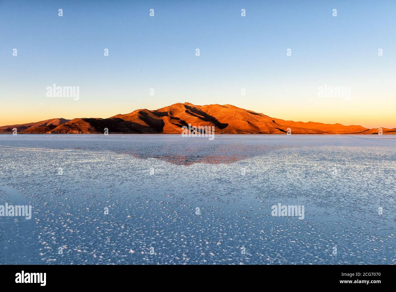 Mountain reflections at sunrise, Uyuni Salt flat, Altiplano, Bolivia Stock Photo