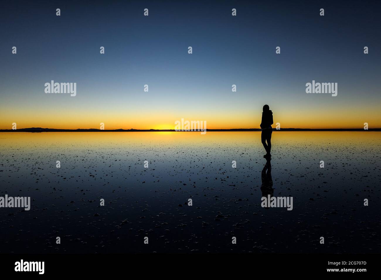 Silhouette of a man at sunset, Uyuni Salt flat, Altiplano, Bolivia Stock Photo