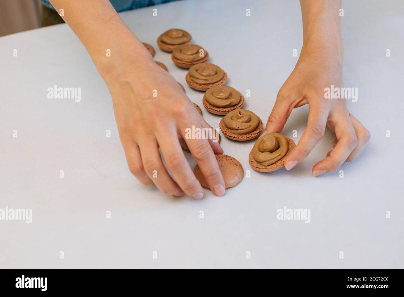 Woman making chocolate macaroons Stock Photo