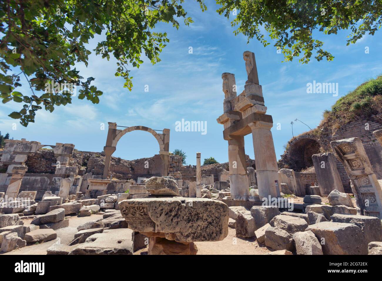 Ephesus, near Selcuk, Izmir Province, Turkey.  Temple of Domitian with the arch of the Fountain of Domitian in background. Stock Photo
