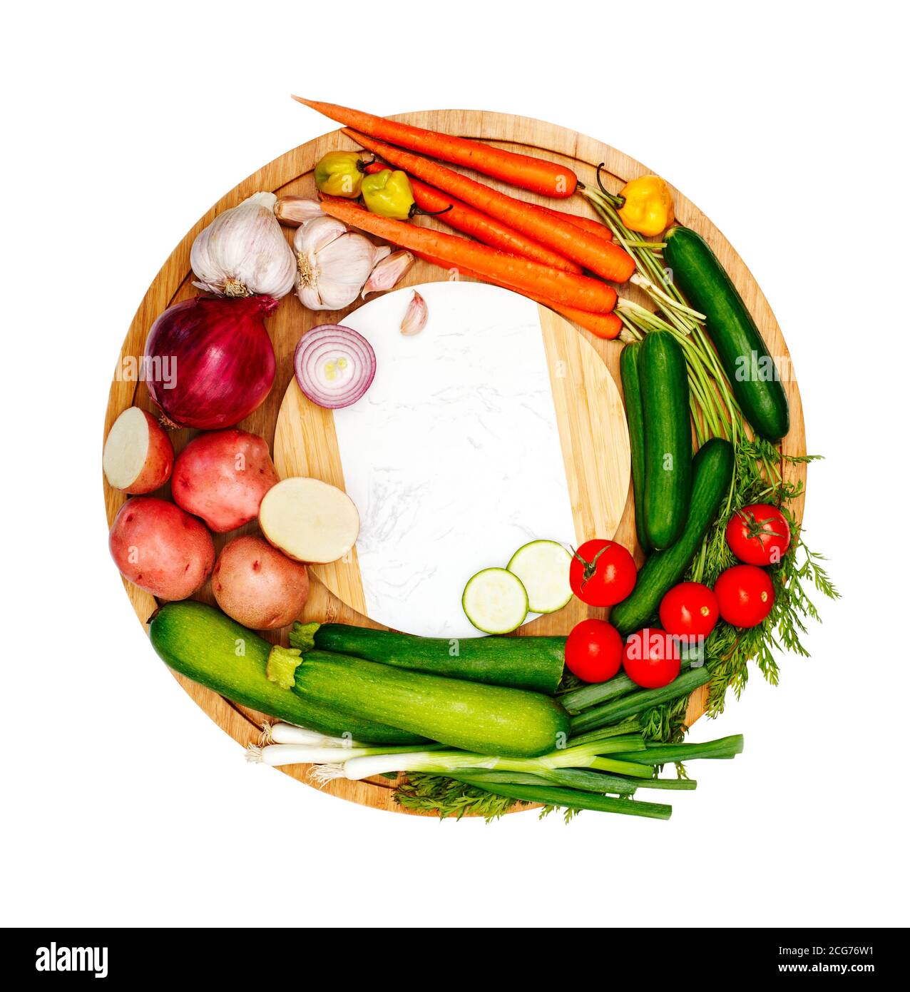 Fresh fruit and vegetables on a circular chopping board Stock Photo