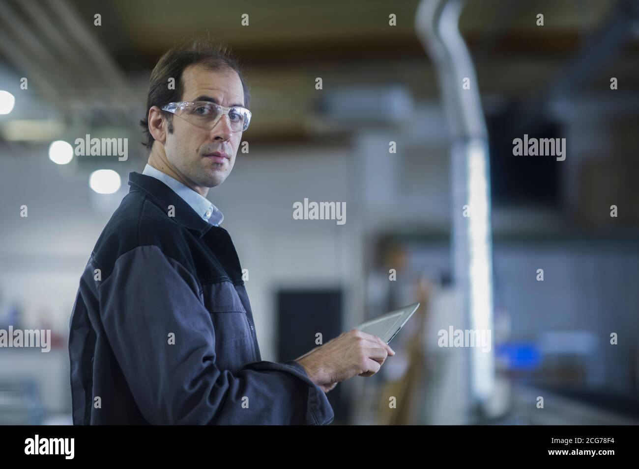 Engineer using a digital tablet in a factory, Germany Stock Photo