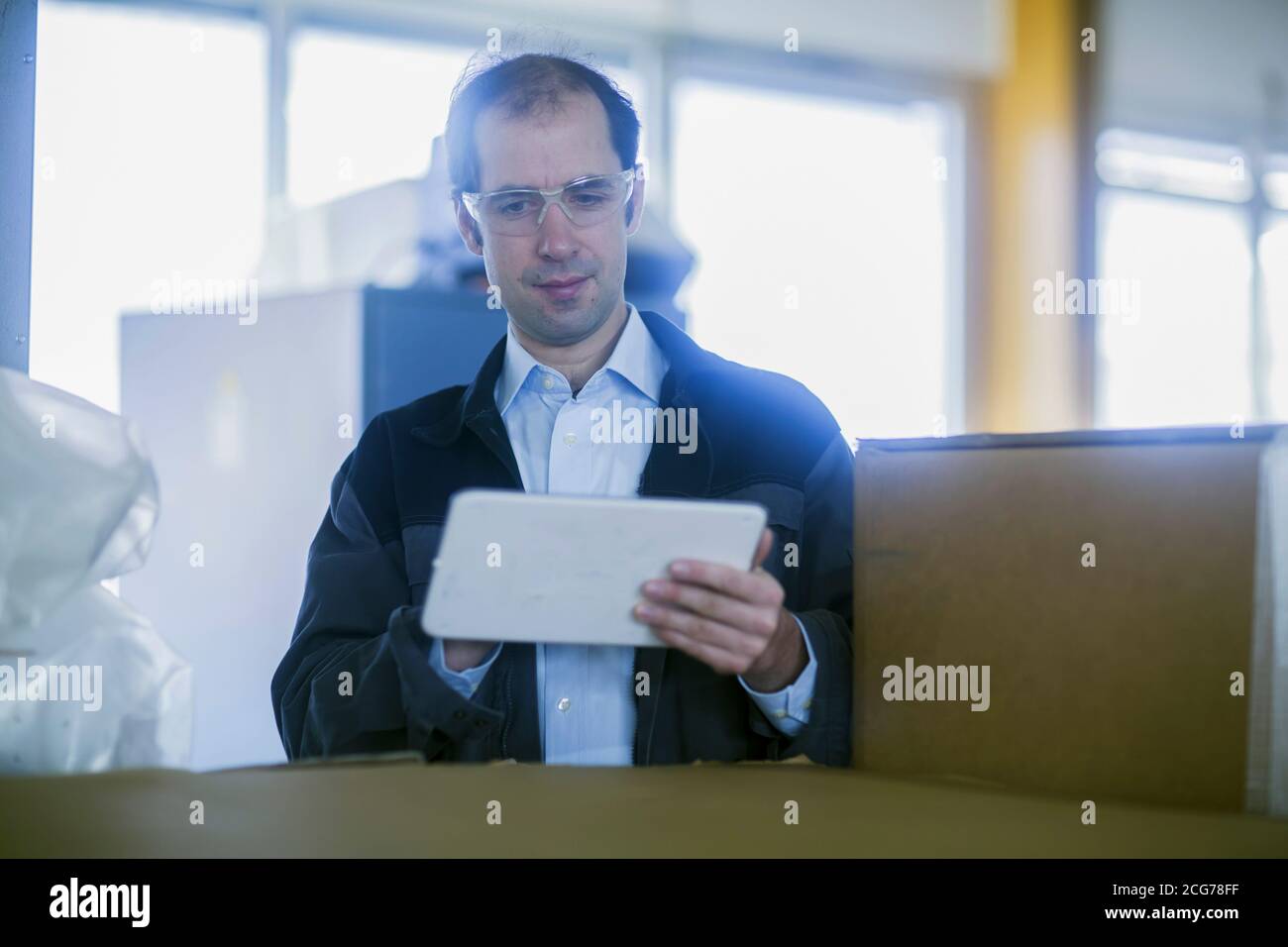 Engineer using a digital tablet in a factory, Germany Stock Photo