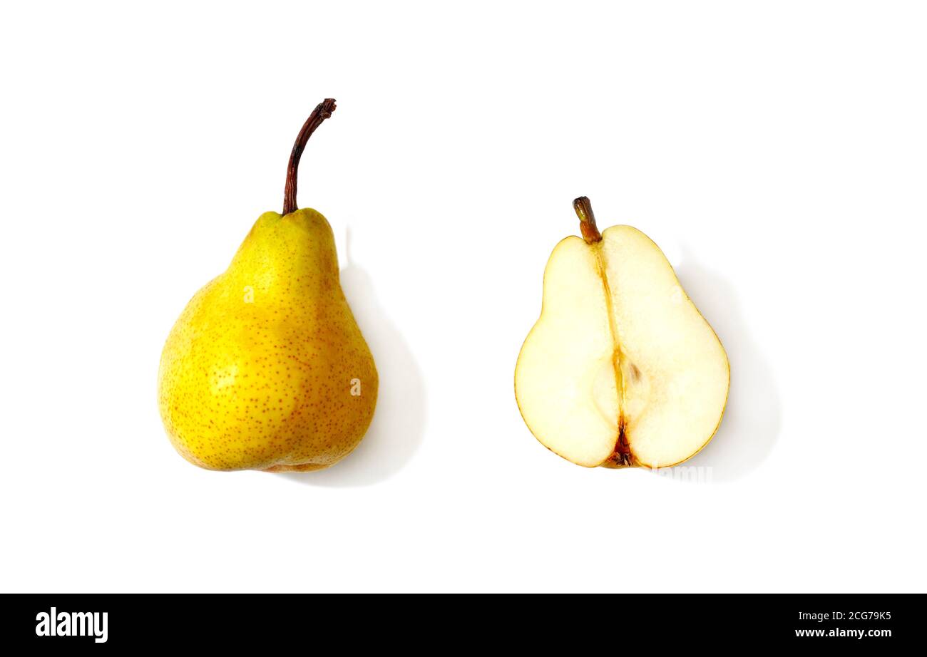 Whole pear next to a halved pear Stock Photo