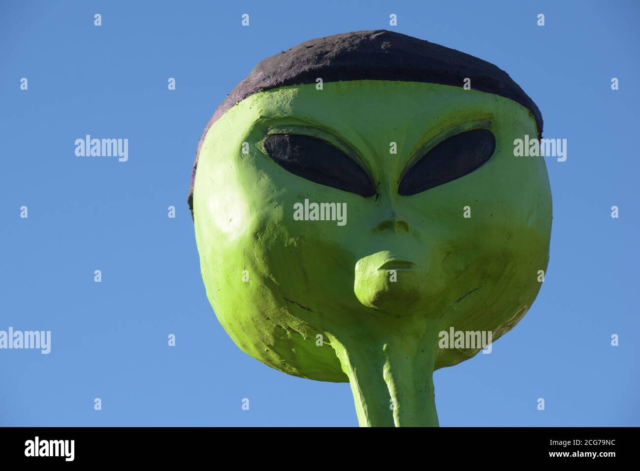alien green alien ufo on the ground flying saucer Stock Photo