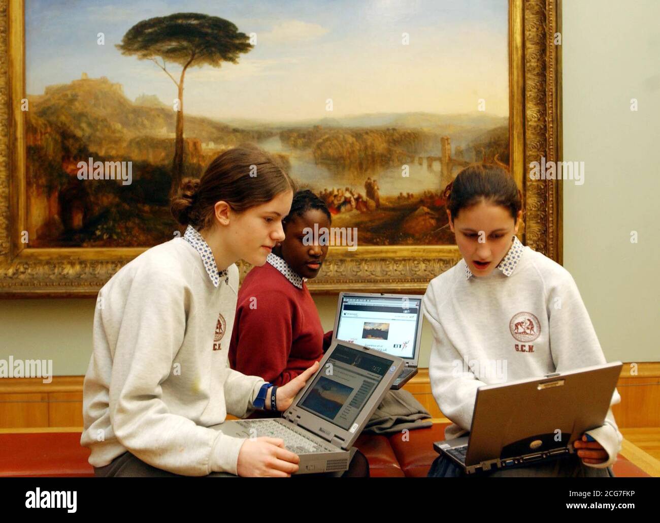 Pupils from Great Coat Hospital School, London, (L-R) Jennifer Evans, Deborah Ogwnwobi and Alice Theodorou, examine Turner paintings during the launch of 'Hidden Turners,' at the Tate Britain gallery, London, where thousands of rare works by JMW Turner, went on display.  * for the first time thanks to a new online gallery. The Turner Bequest goes online from 1/3/02. Stock Photo
