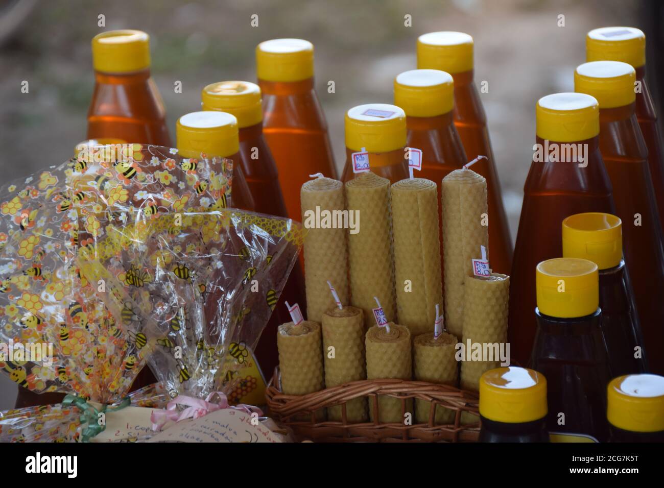 honey products bees honey bottles over table natural wax candles Stock Photo